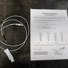 Tempearture probe with paper stating Certicate of Calibration.