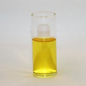 glass cylinder with open top and filled half way with yellow liquid.