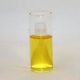 glass cylinder with open top and filled half way with yellow liquid.